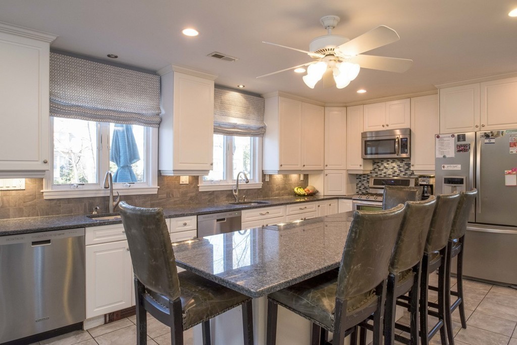 155 Eastbourne Road Newton, MA 02459 - Photo 9 of 25 a large kitchen with kitchen island granite countertop a island a sink a stove a dining table and chairs