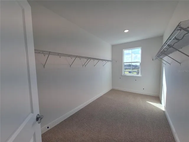 a spacious bathroom with a shower and a sink
