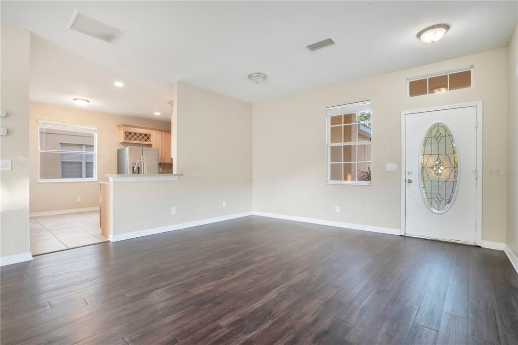 15031 Skip Jack Loop Lakewood Ranch, FL 34202 - Photo 2 of 27 a view of an empty room with wooden floor and a window