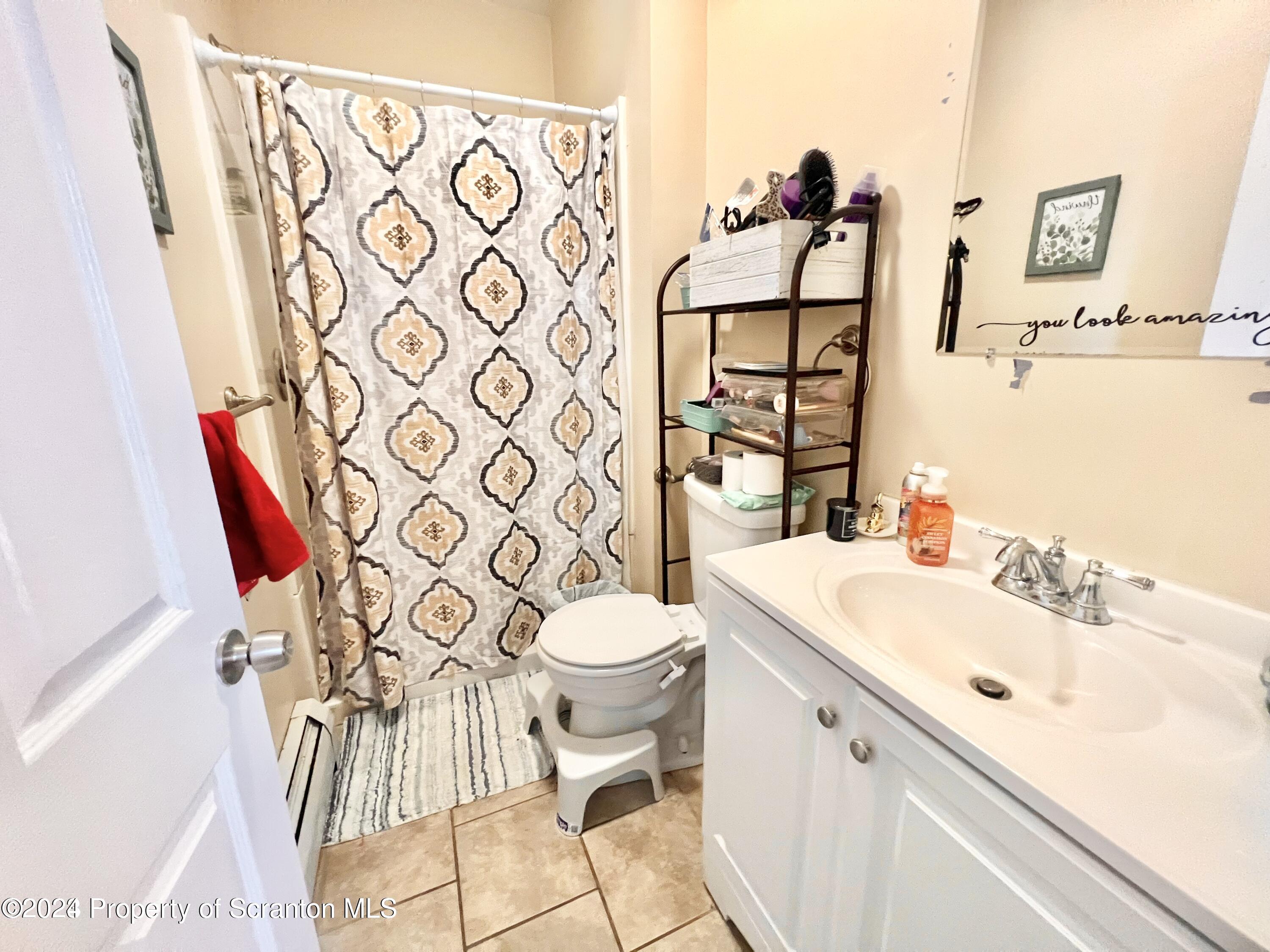 721 Columbia Street, Unit A Scranton, PA 18509 - Photo 4 of 12 a bathroom with a sink toilet and shower