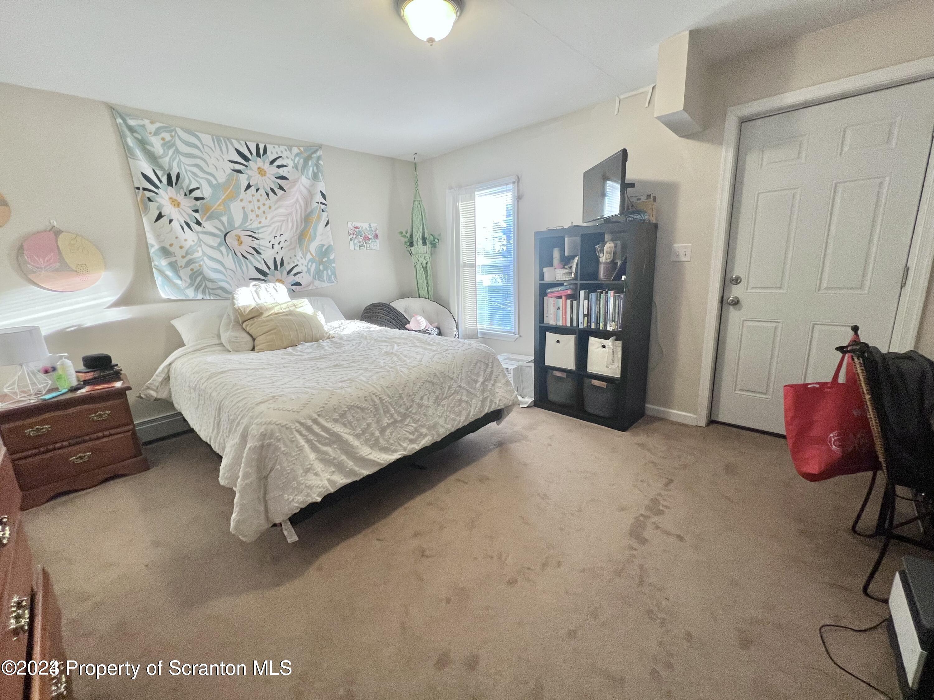 721 Columbia Street, Unit A Scranton, PA 18509 - Photo 6 of 12 a bedroom with a bed and walk in closet