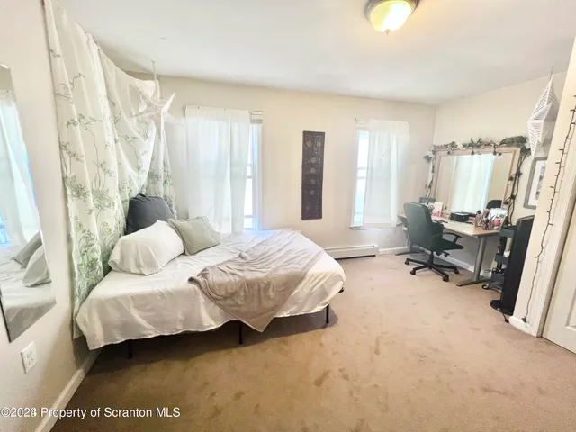 a spacious bedroom with a bed and a couch