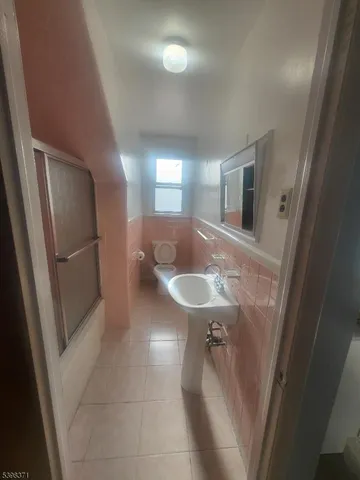 a bathroom with a sink a toilet a mirror and vanity