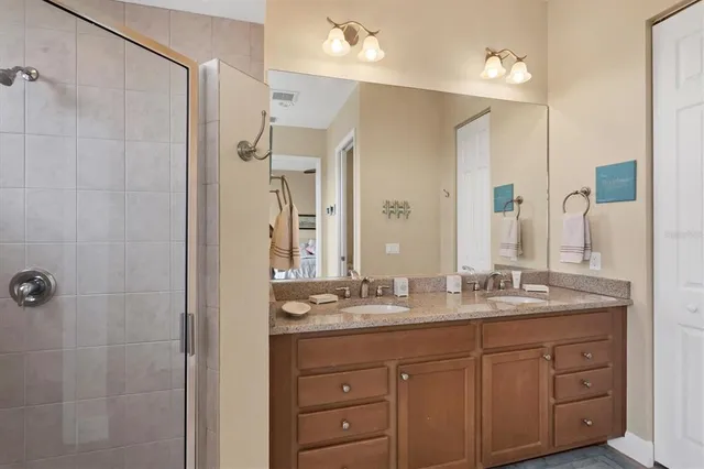 a bathroom with a double vanity sink mirror and double