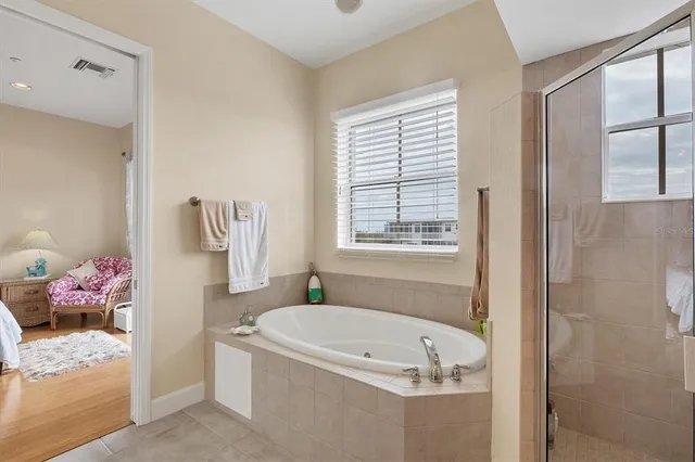 a bath room with a bath tub and a shower