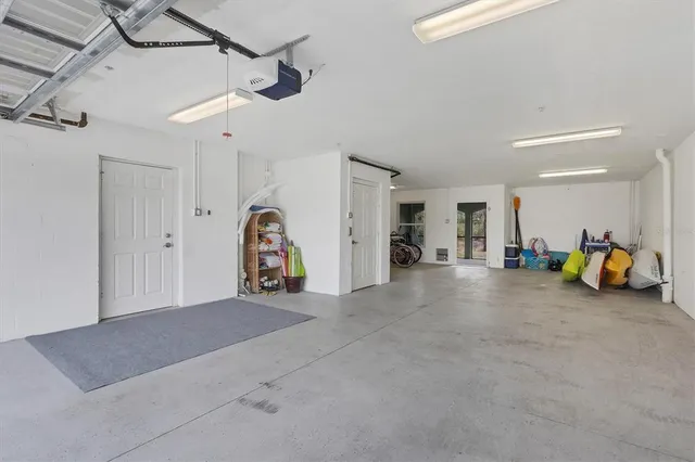 a view of a room with gym equipment and a ceiling fan
