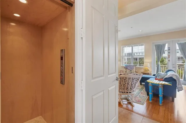 a view of a livingroom with furniture and floor to ceiling window