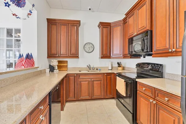 a kitchen with stainless steel appliances granite countertop a stove a sink and dishwasher cabinets with wooden floor