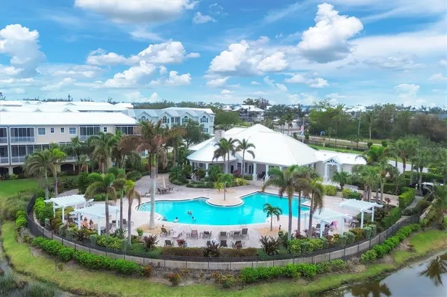 a view of a house with a yard and potted plants