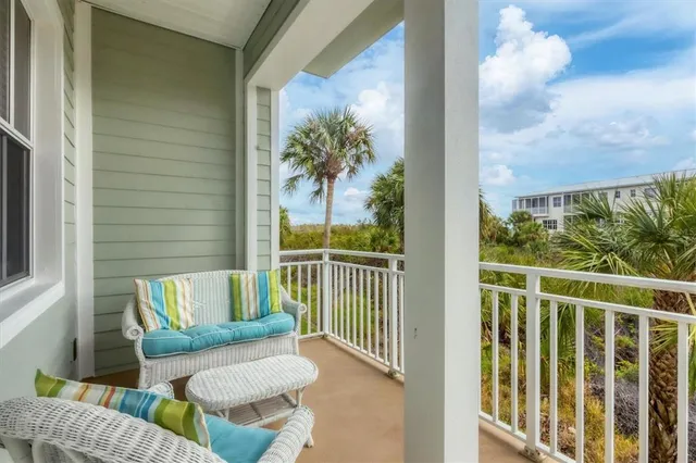 a view of a porch with furniture and a potted plant