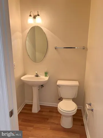 a bathroom with a sink toilet and a mirror