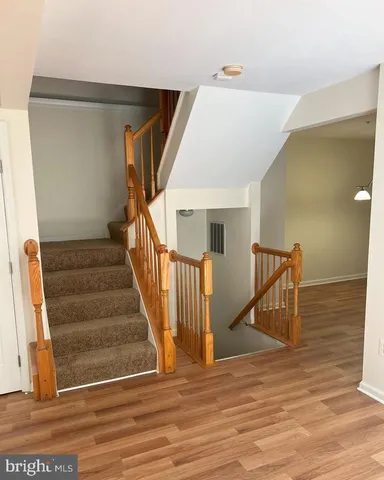a view of entryway and hall with wooden floor