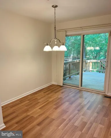 a view of a room with wooden floor and outdoor space