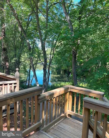 a view of a wooden deck next to a yard