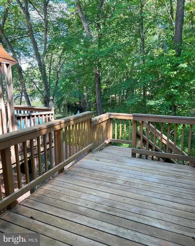 a view of house with deck and outdoor seating