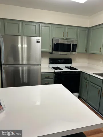 a kitchen with a refrigerator and a sink