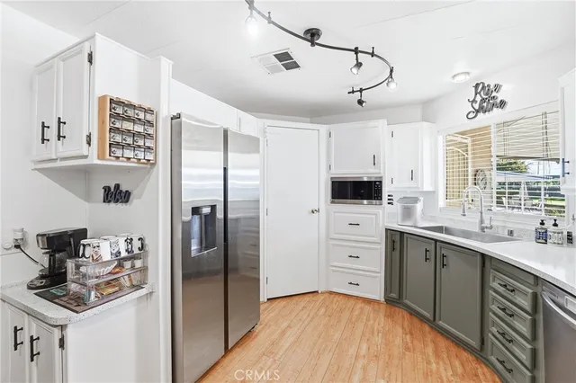 a kitchen with stainless steel appliances a refrigerator sink and cabinets