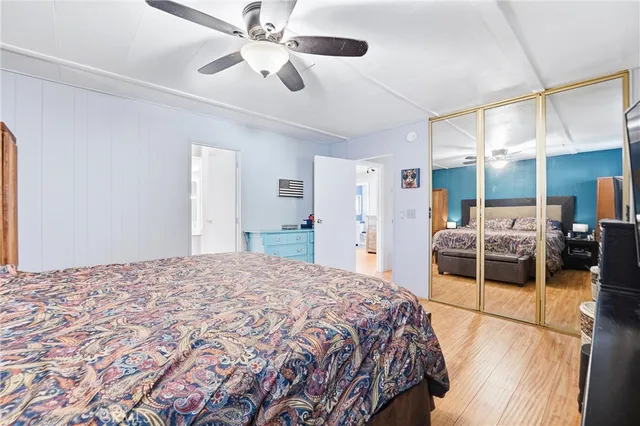 a spacious bedroom with a large bed and a chandelier