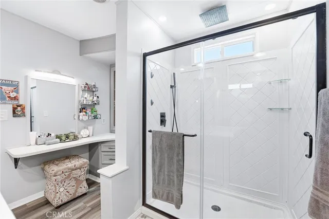 a bathroom with a bathtub shower sink and mirror
