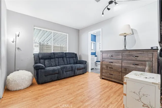 a living room with furniture and a dresser