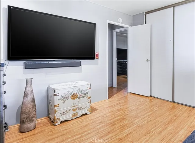 a view of a livingroom with wooden floor and a flat screen tv