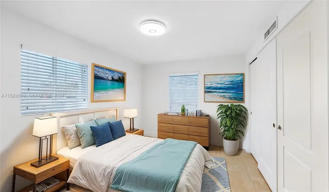 a bedroom with a bed and a potted plant