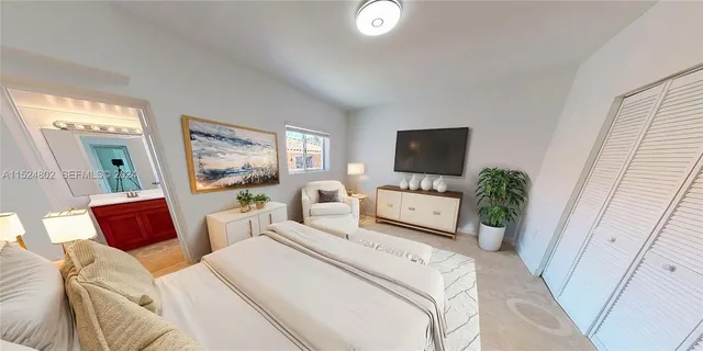 a bedroom with furniture a flat screen tv and a bed