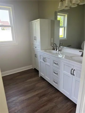 a bathroom with a double vanity sink and mirror