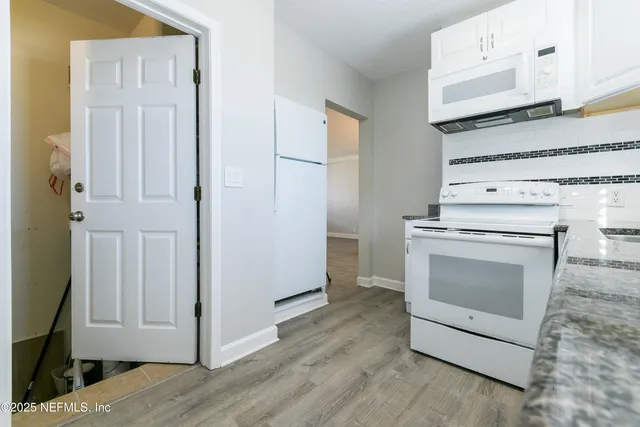 a kitchen with a stove and a microwave
