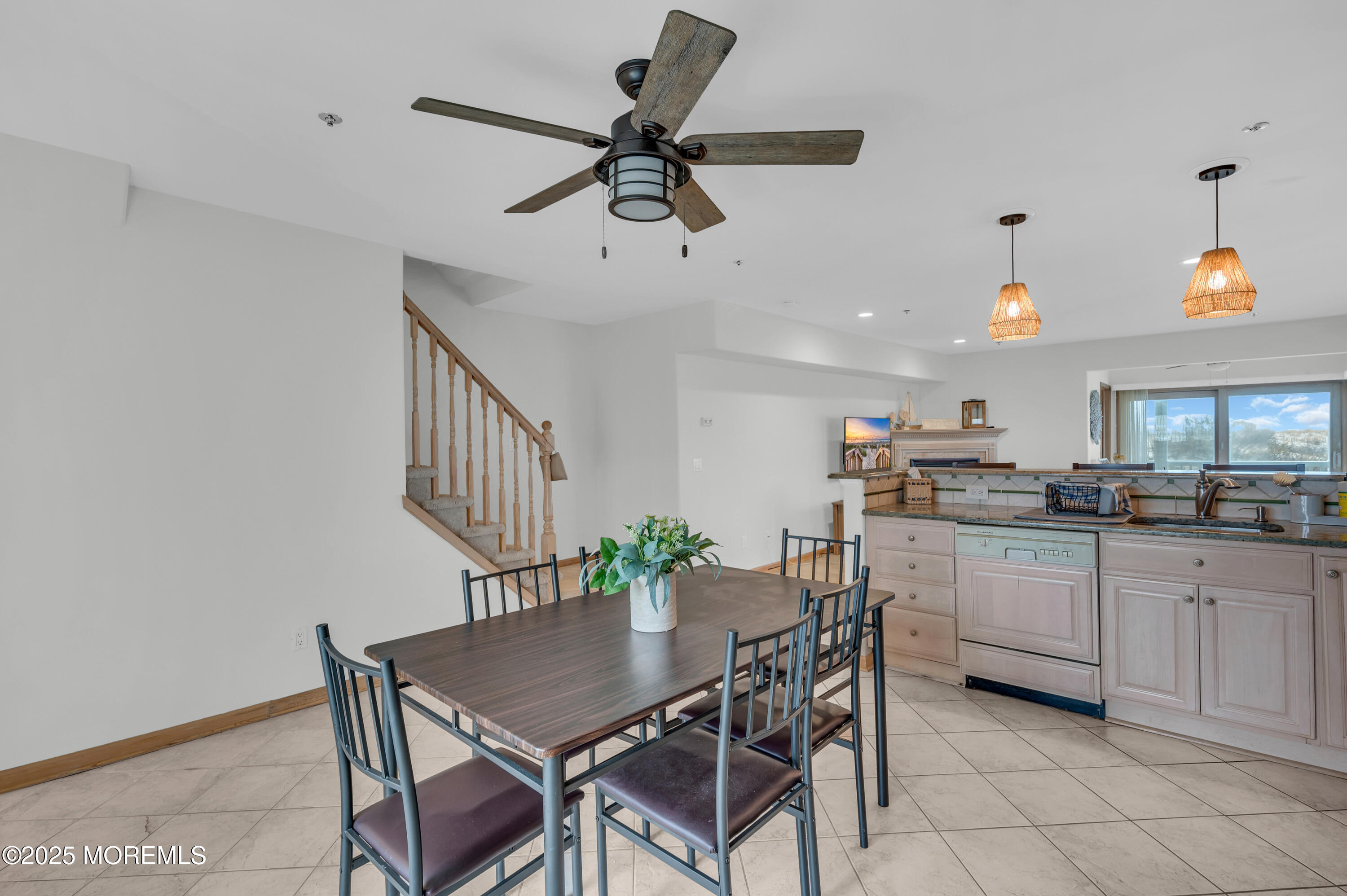 15 East Tuna Way, Unit B Lavallette, NJ 08735 - Photo 17 of 33 a kitchen with a dining table chairs and white cabinets
