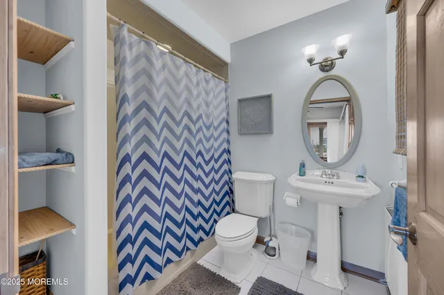 a bathroom with a sink mirror vanity and toilet