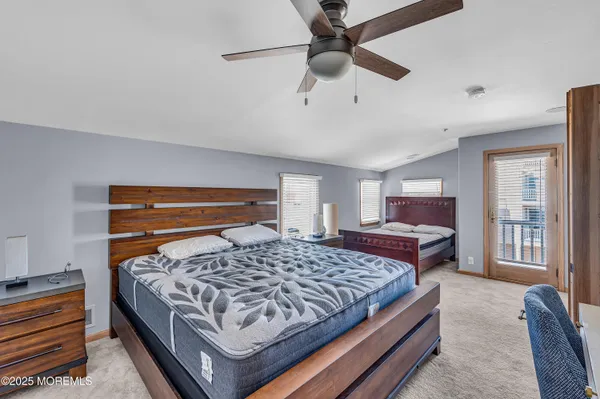 a bedroom with a bed lamp and a fireplace