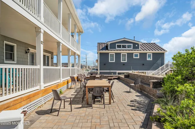 a view of a patio with table and chairs and potted plants