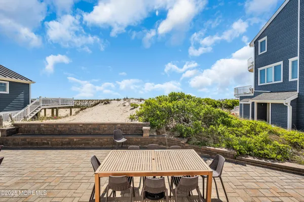 a backyard of a house with barbeque oven table and chairs