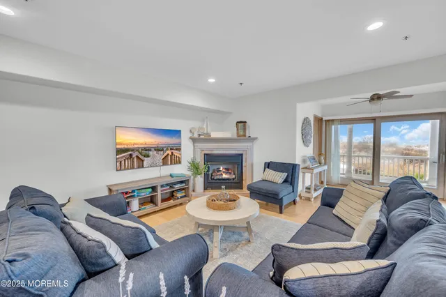 a living room with furniture large window and a fireplace