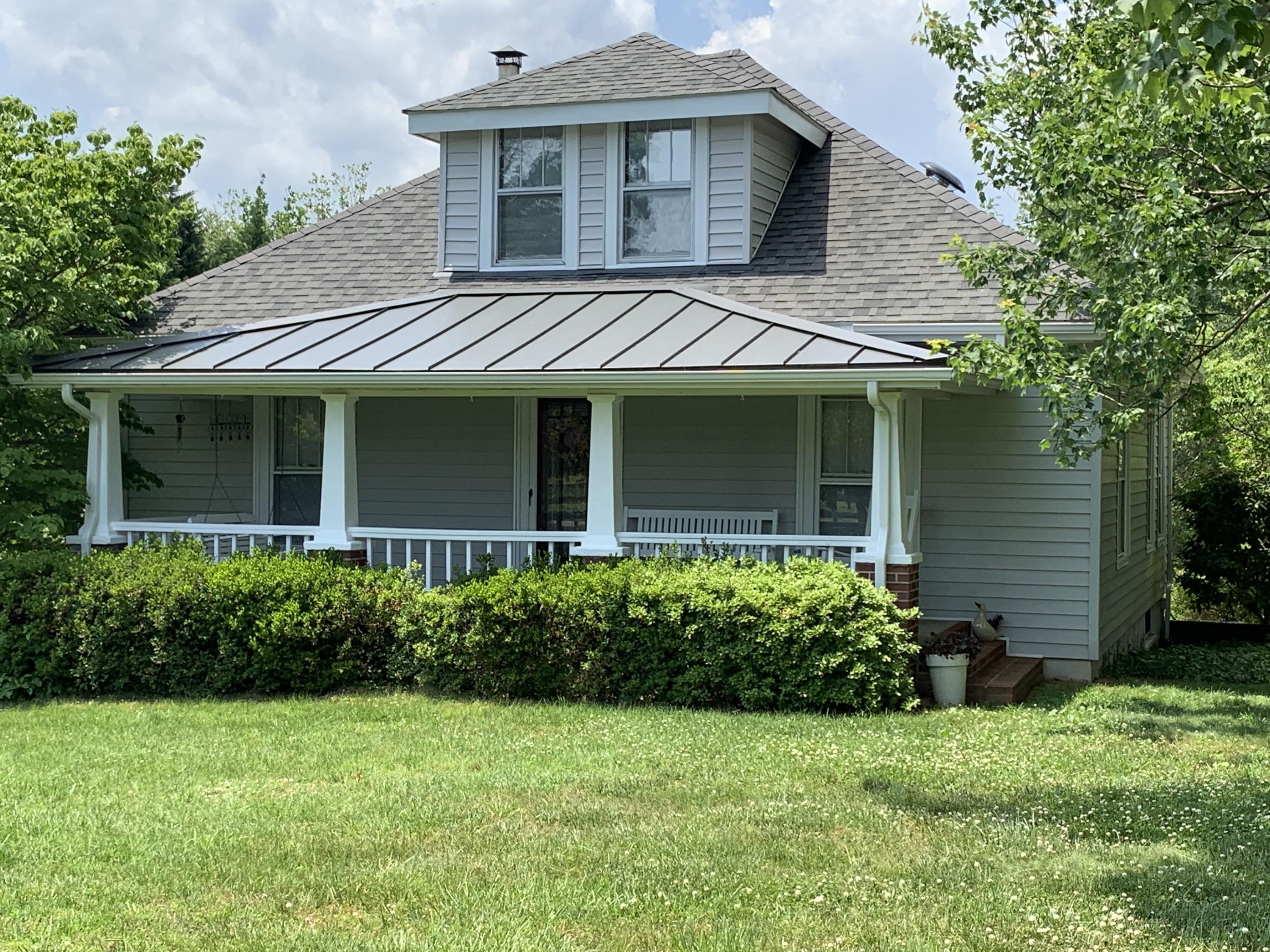 1763 Morgans Mill Road Goodview, VA 24095 - Photo 1 of 46 a front view of a house with a garden