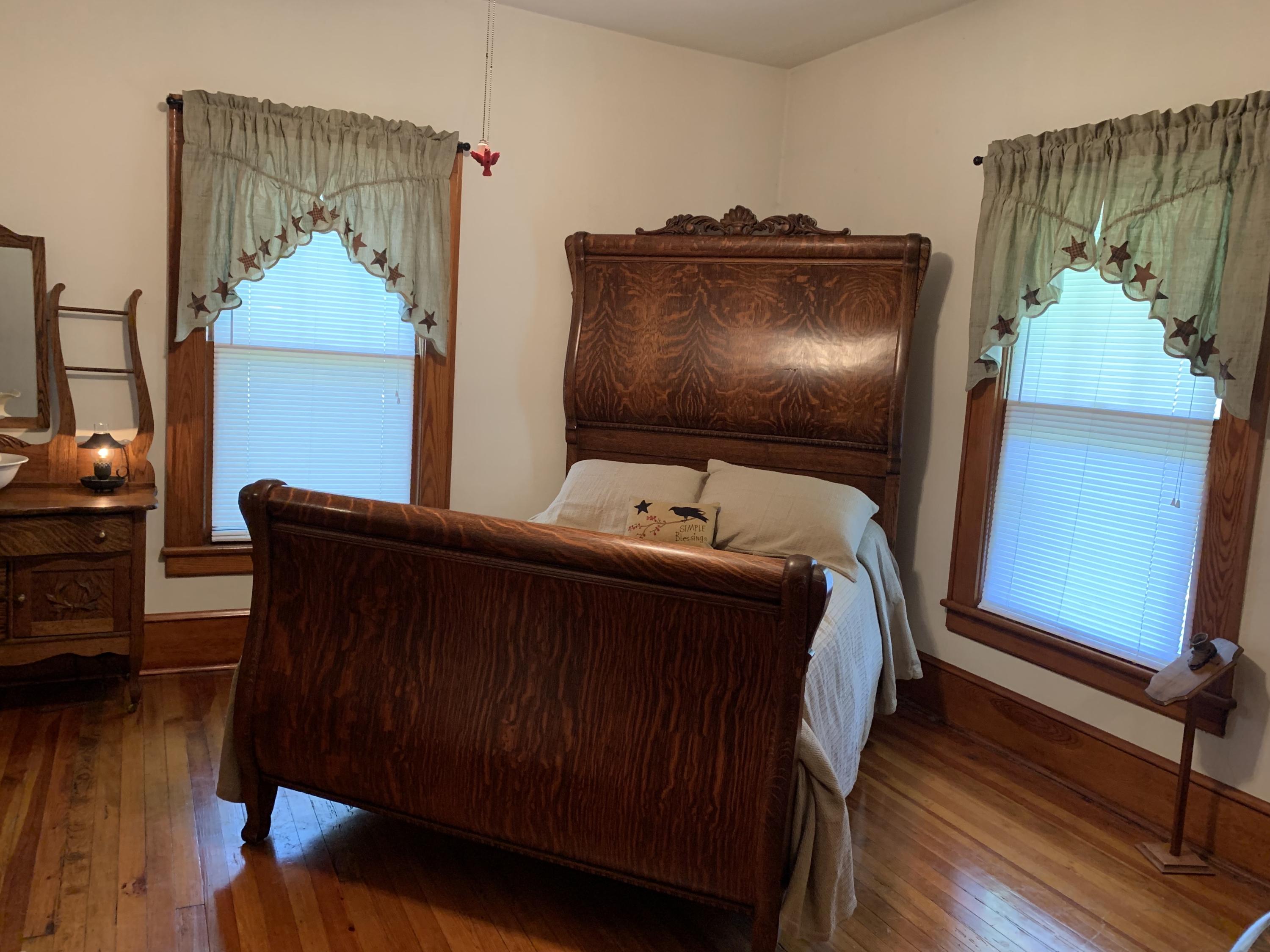 1763 Morgans Mill Road Goodview, VA 24095 - Photo 2 of 46 a bedroom with a bed and wooden floor