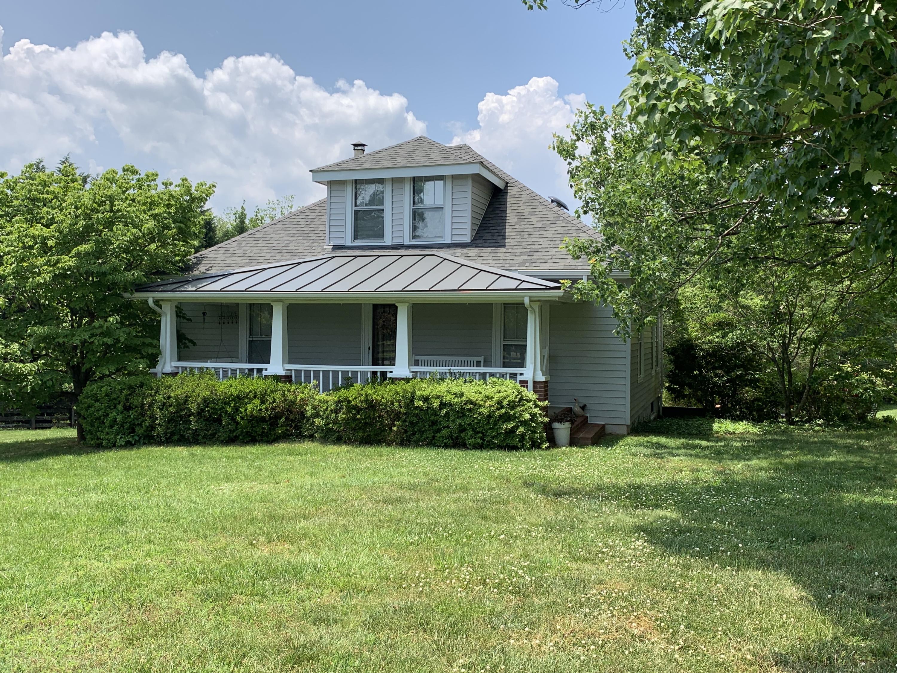 1763 Morgans Mill Road Goodview, VA 24095 - Photo 18 of 46 a front view of a house with a yard and garage