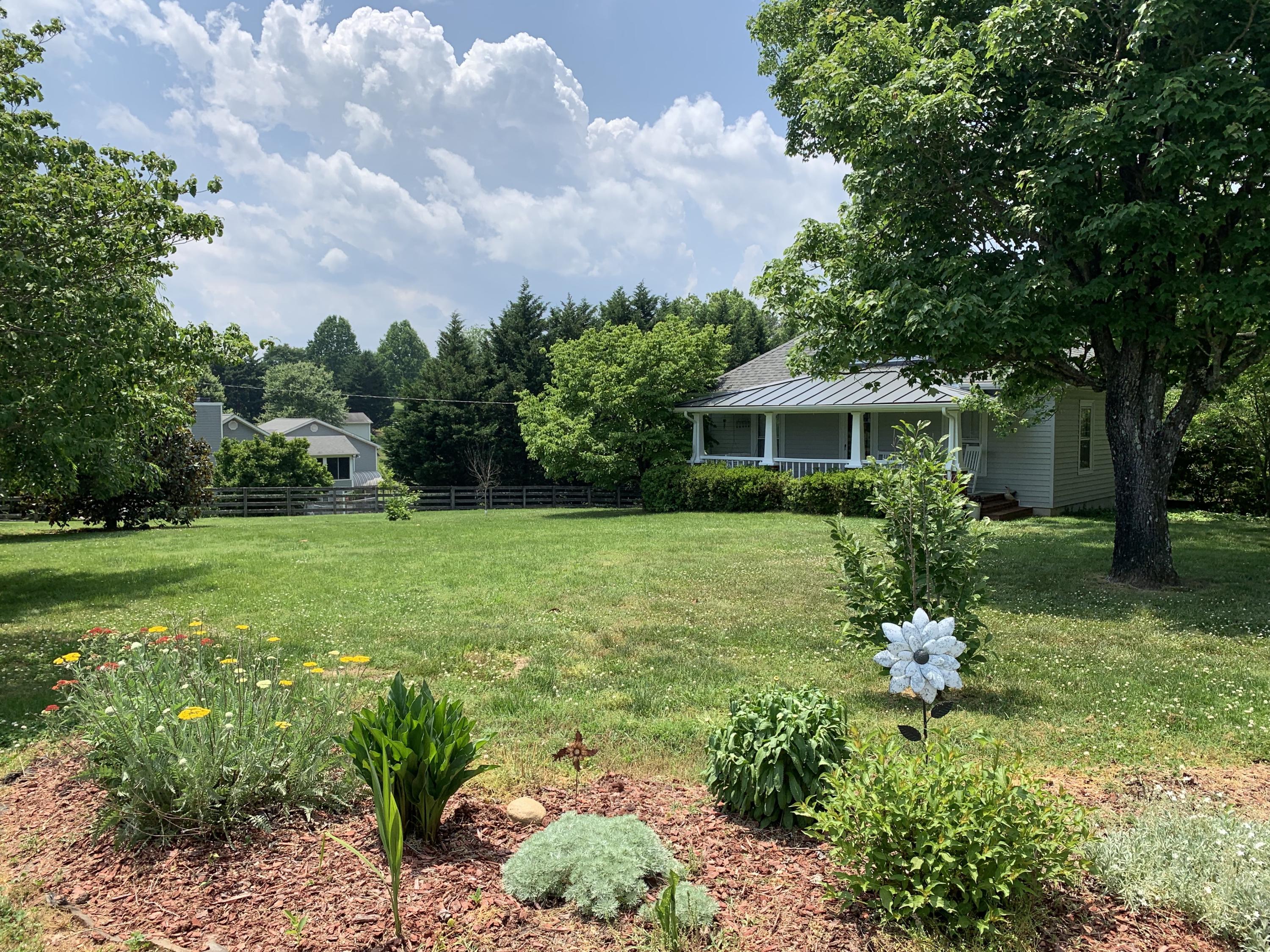 1763 Morgans Mill Road Goodview, VA 24095 - Photo 19 of 46 a front view of a house with garden