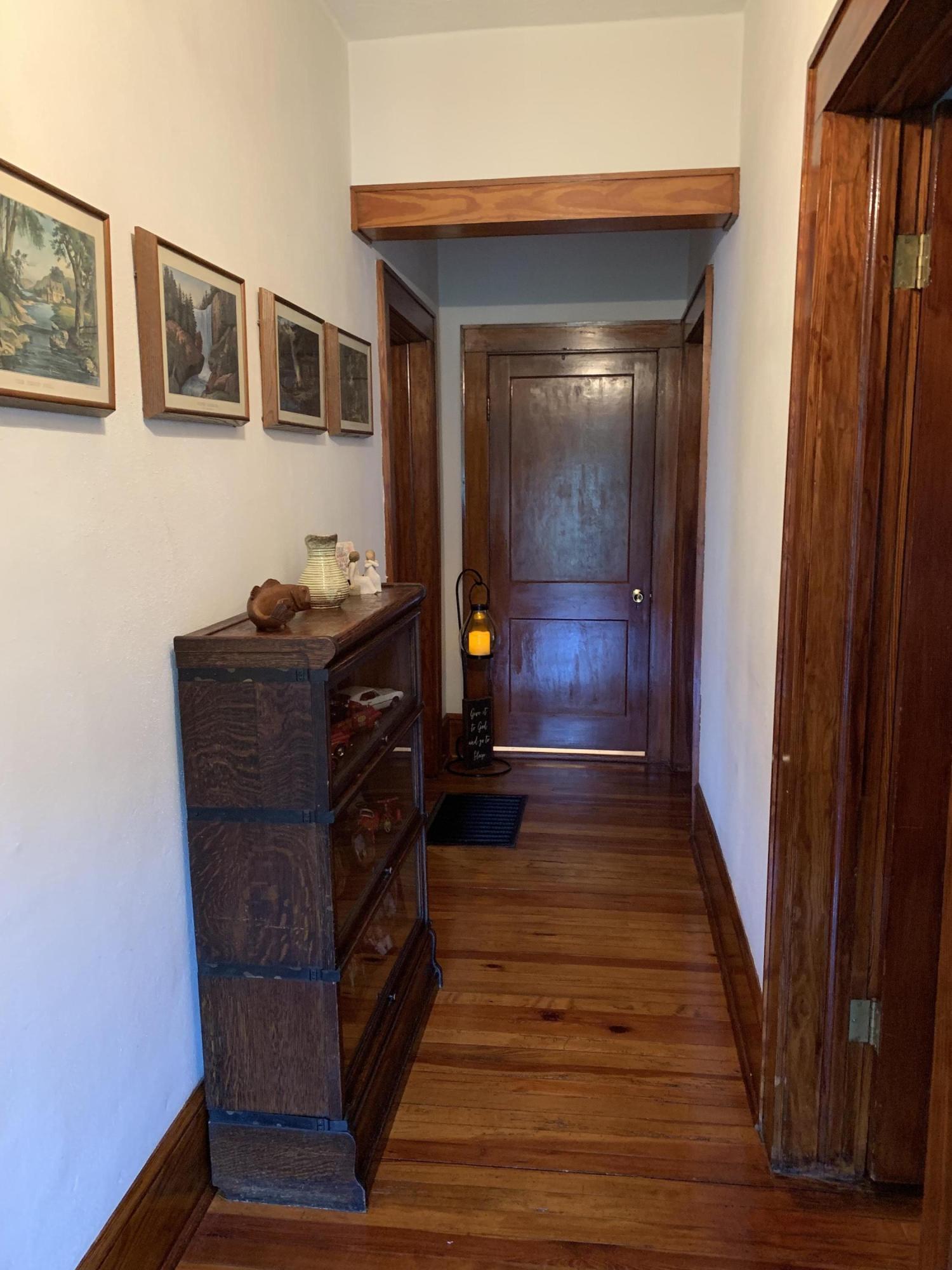 1763 Morgans Mill Road Goodview, VA 24095 - Photo 23 of 46 a view of a hallway with wooden floor and furniture