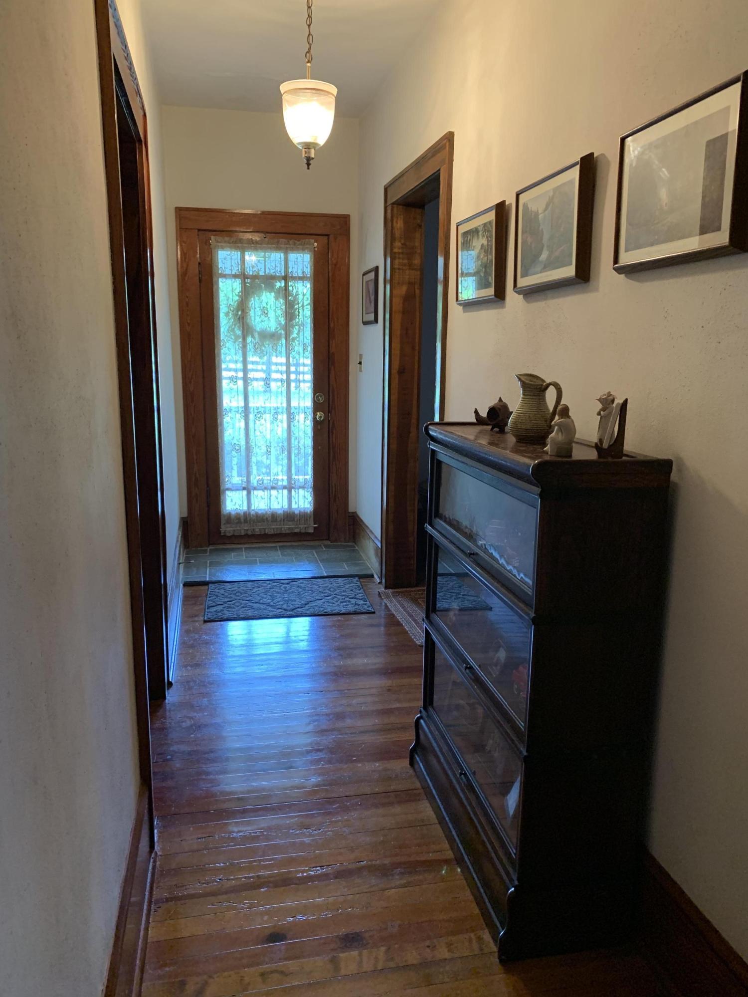 1763 Morgans Mill Road Goodview, VA 24095 - Photo 24 of 46 a hallway with wooden floor and windows