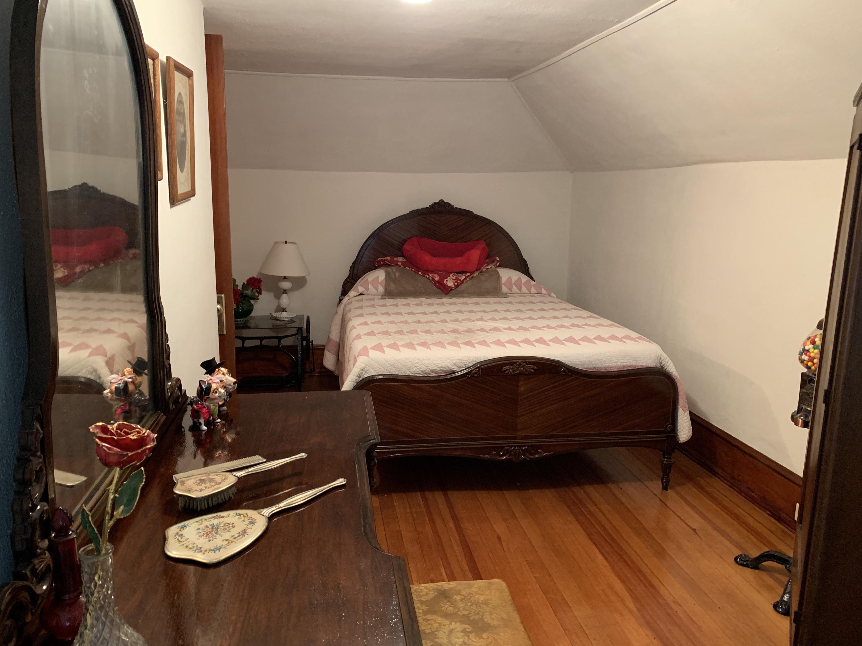 1763 Morgans Mill Road Goodview, VA 24095 - Photo 4 of 46 a bedroom with a bed and dresser with wooden floor