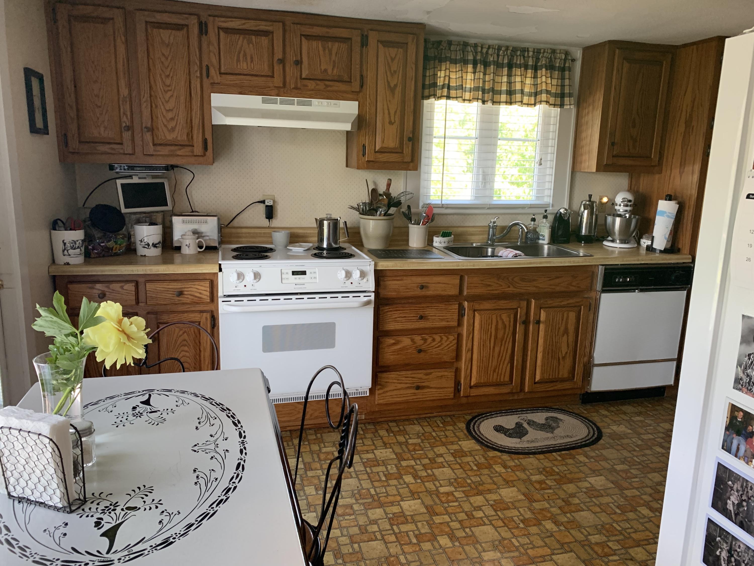 1763 Morgans Mill Road Goodview, VA 24095 - Photo 32 of 46 a kitchen with a stove a sink and a refrigerator