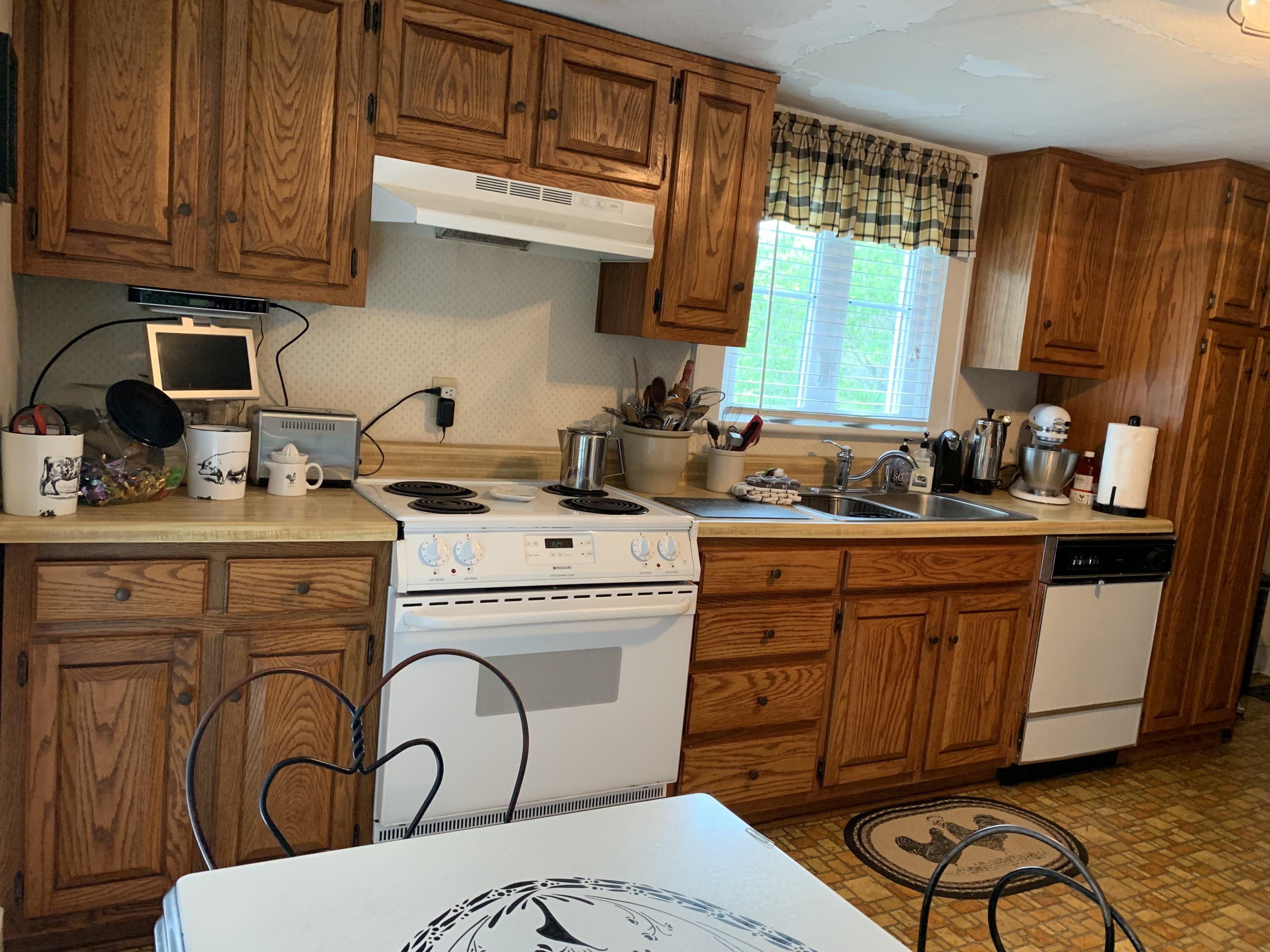 1763 Morgans Mill Road Goodview, VA 24095 - Photo 35 of 46 a kitchen with a sink a stove and cabinets