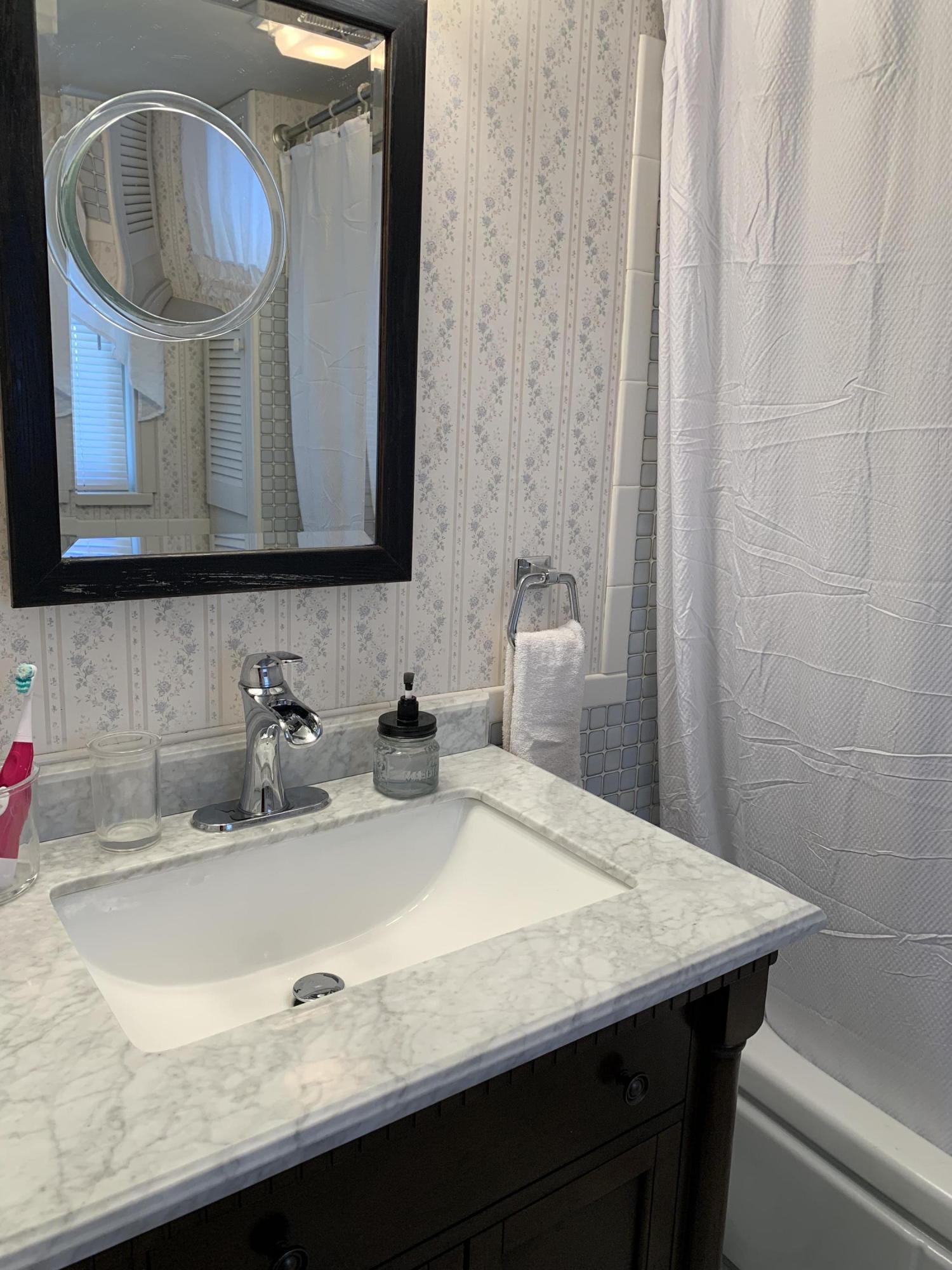 1763 Morgans Mill Road Goodview, VA 24095 - Photo 45 of 46 a bathroom with a granite countertop sink a mirror and vanity