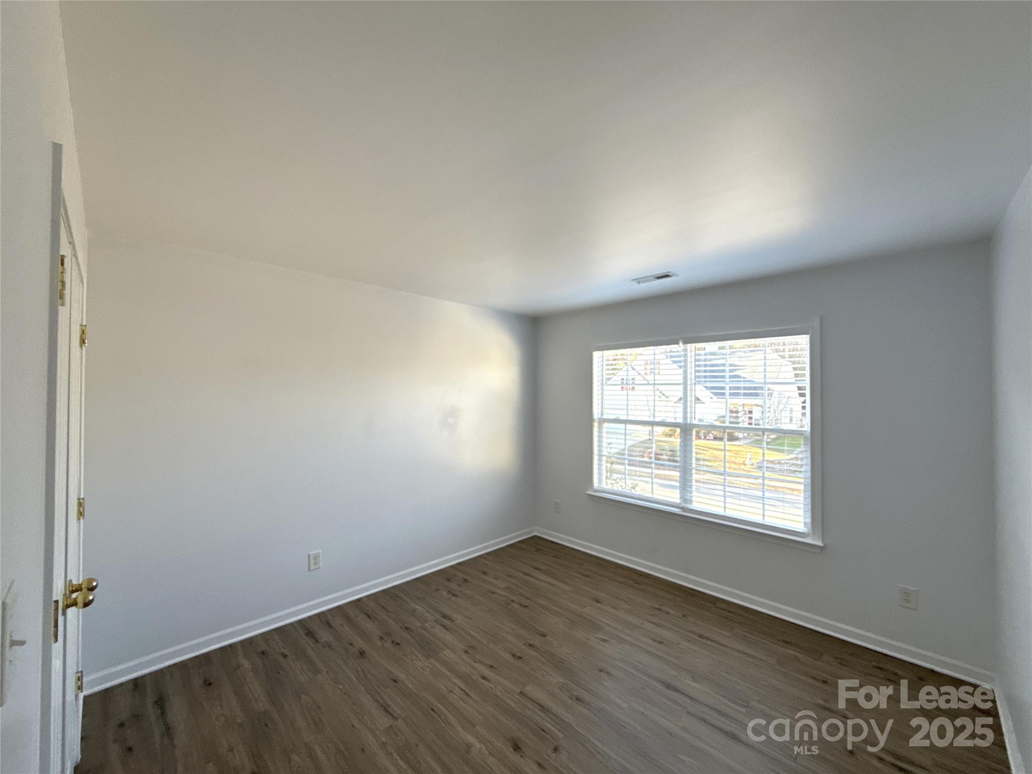 3415 Cole Mill Road Charlotte, NC 28270 - Photo 15 of 18 an empty room with wooden floor and windows