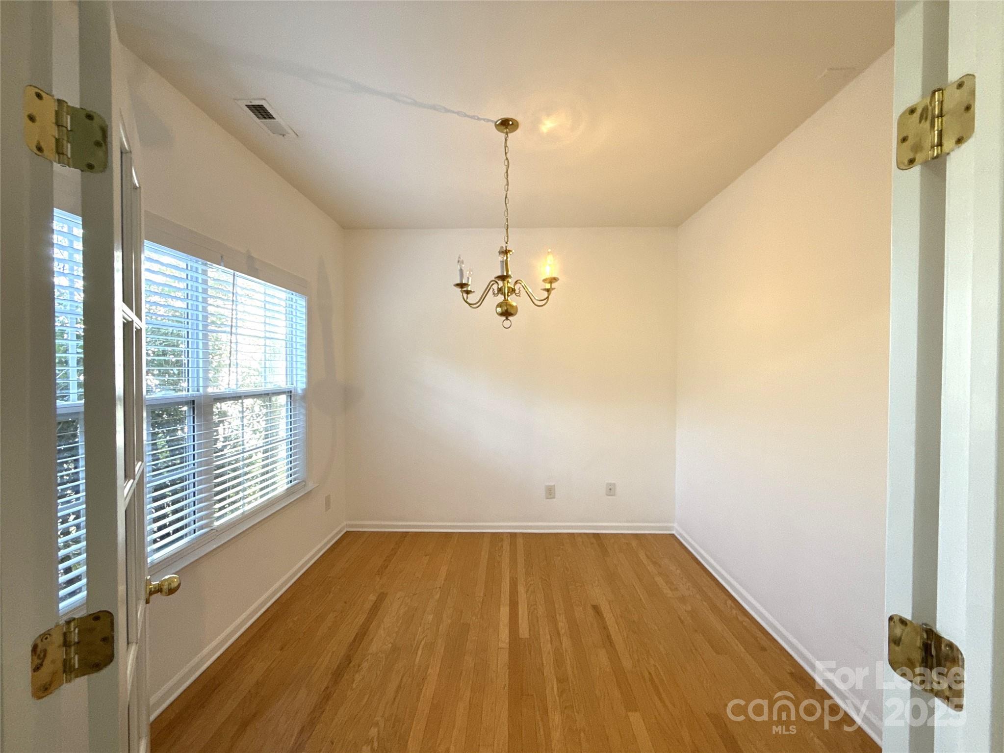 3415 Cole Mill Road Charlotte, NC 28270 - Photo 2 of 18 a view of empty room with wooden floor and fan
