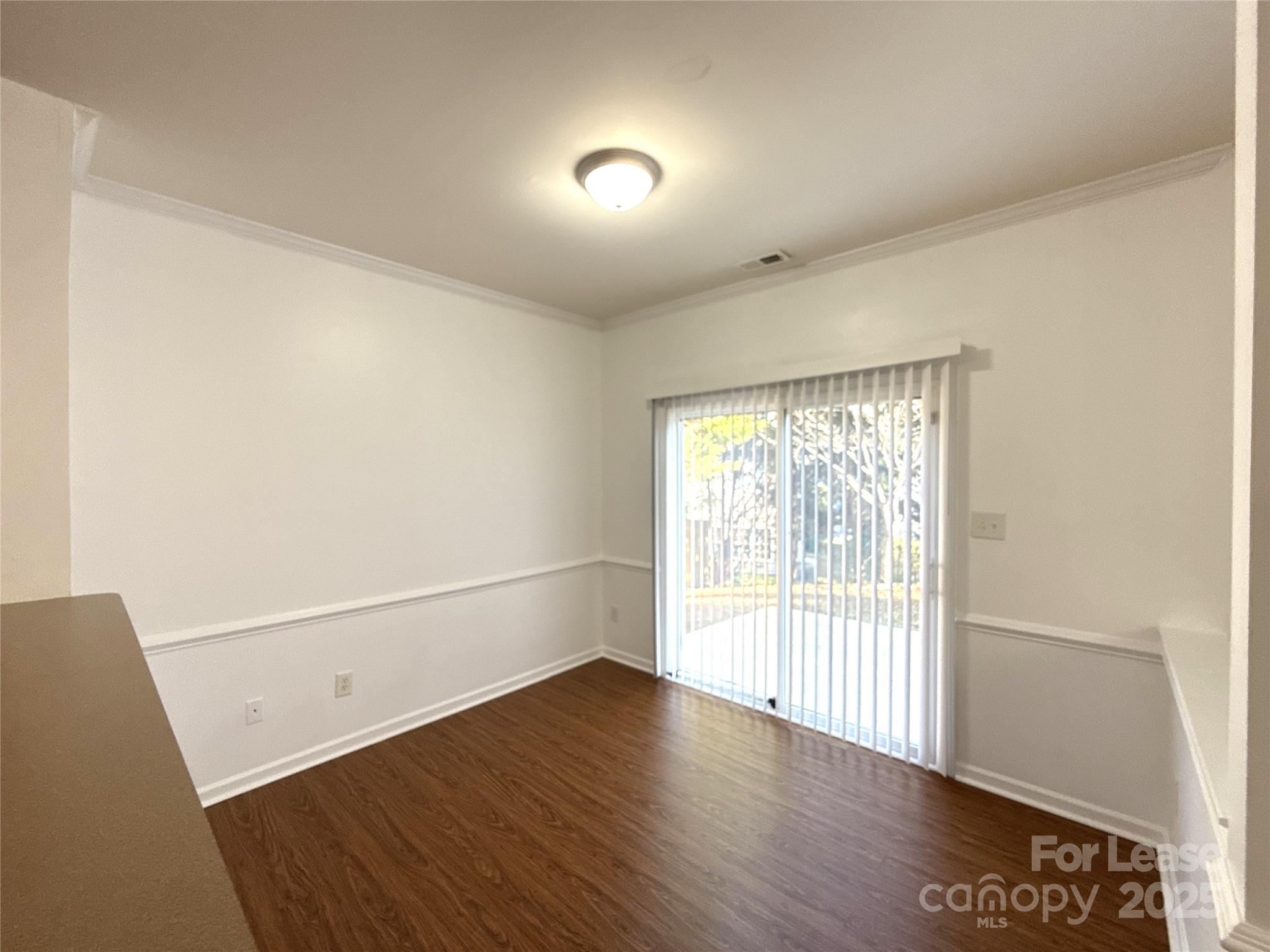3415 Cole Mill Road Charlotte, NC 28270 - Photo 5 of 18 a view of an empty room with wooden floor and a window