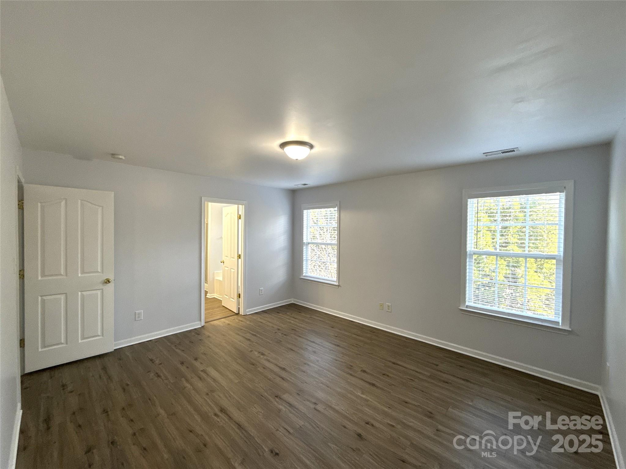 3415 Cole Mill Road Charlotte, NC 28270 - Photo 9 of 18 an empty room with wooden floor and windows