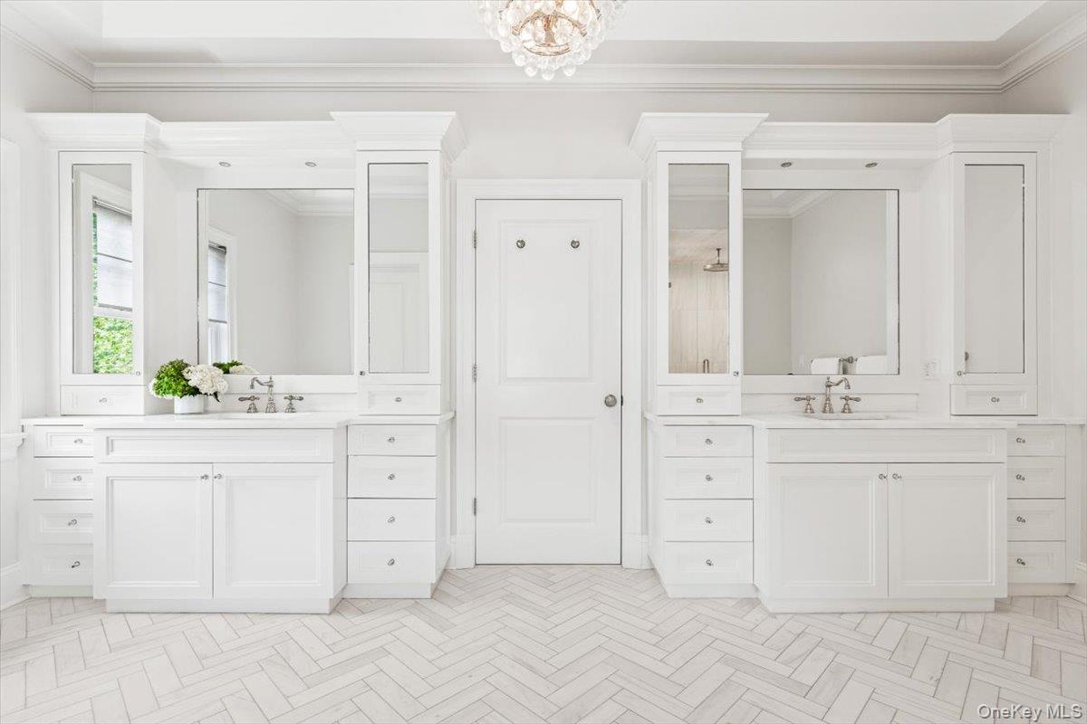 81 Wappanocca Avenue Rye, NY 10580 - Photo 12 of 27 Full bathroom featuring two vanities, ornamental molding, a shower, and a chandelier